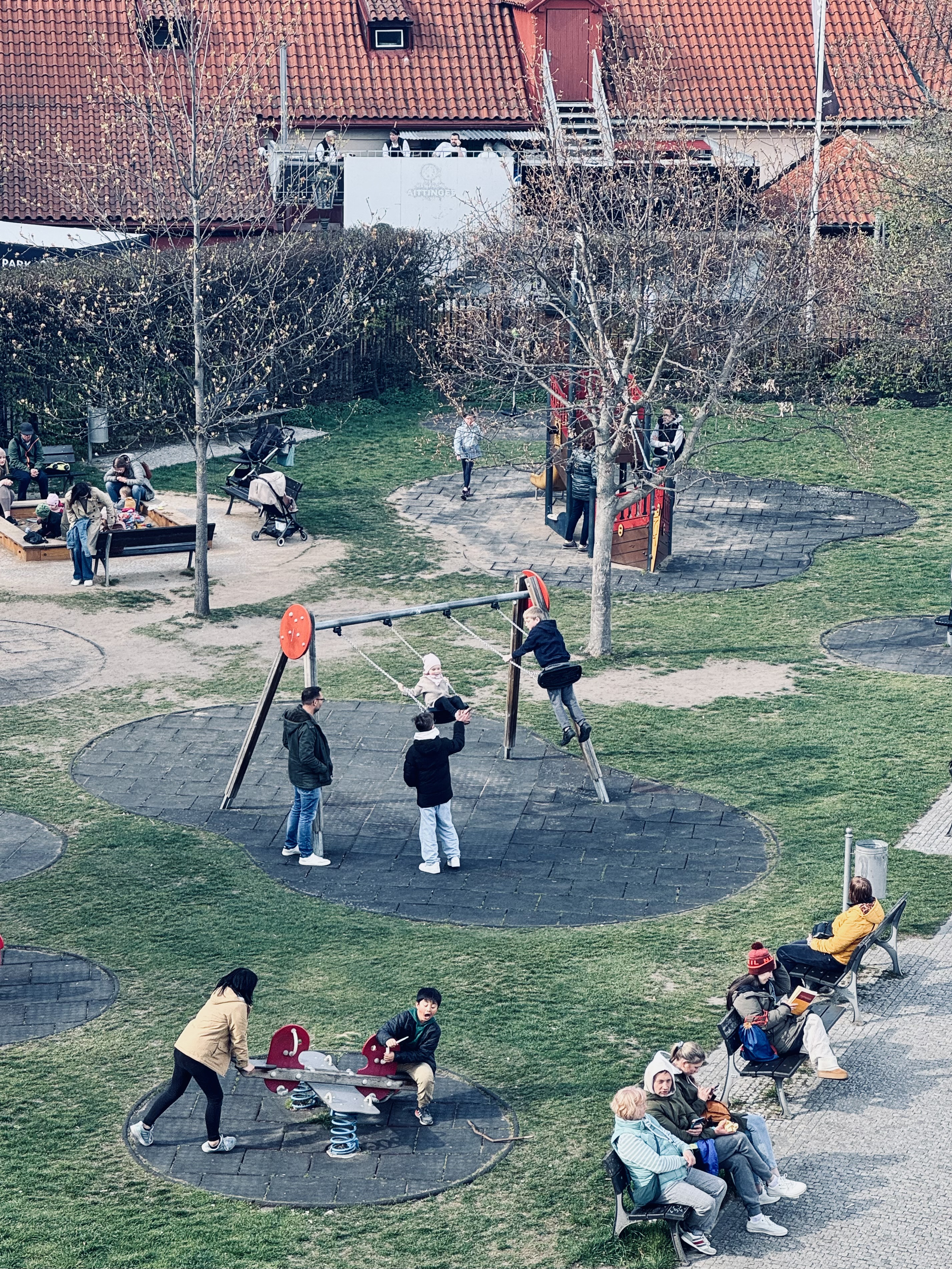 People enjoy an ordinary day at a playground (Prague).